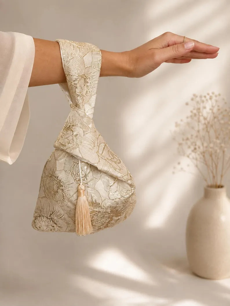 Japanese knot gold bag with a tassel