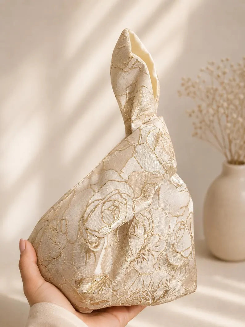 Japanese knot gold bag with a tassel