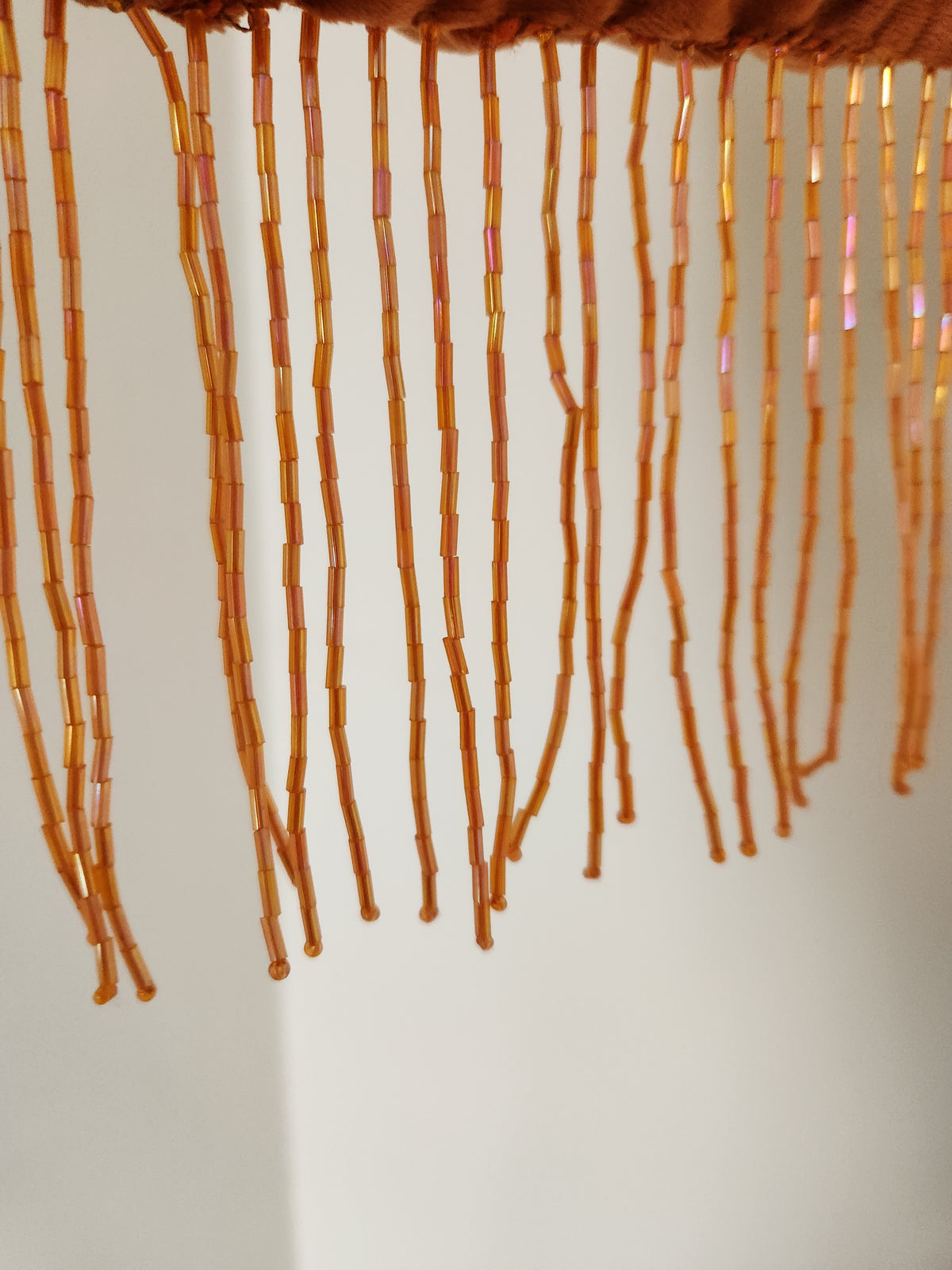 Japanese knot wrist bag with a beaded fringe trim