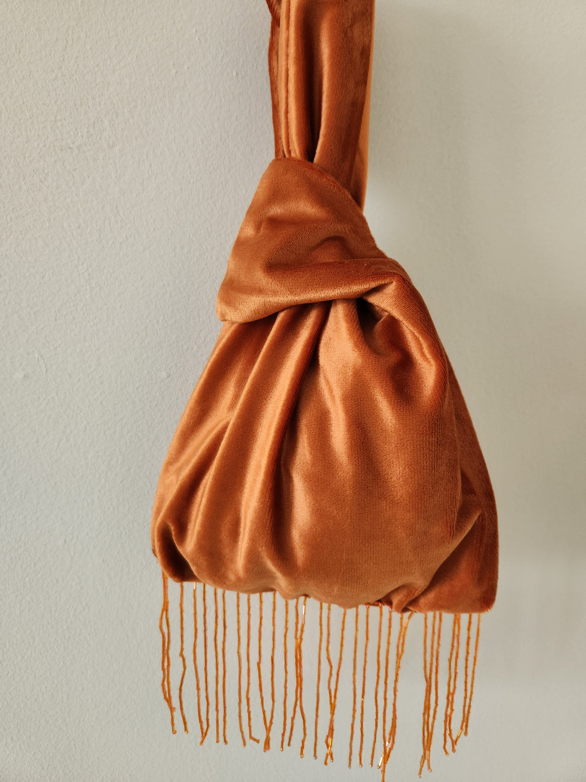 Japanese knot wrist bag with a beaded fringe trim