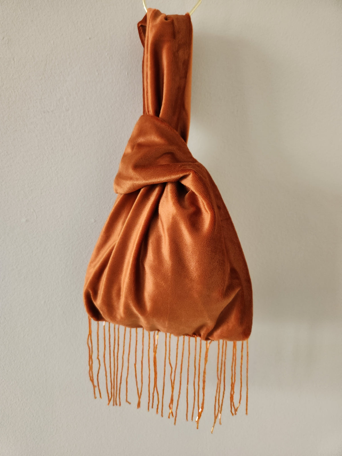 Japanese knot wrist bag with a beaded fringe trim
