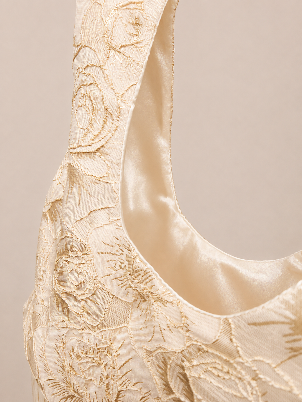 Japanese knot wrist bag in gold with a long fringe trim