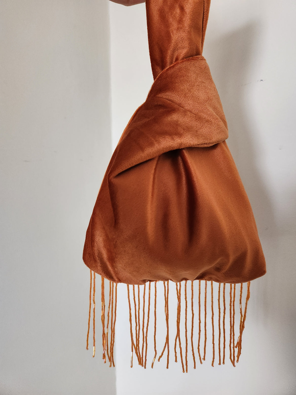 Japanese knot wrist bag with a beaded fringe trim
