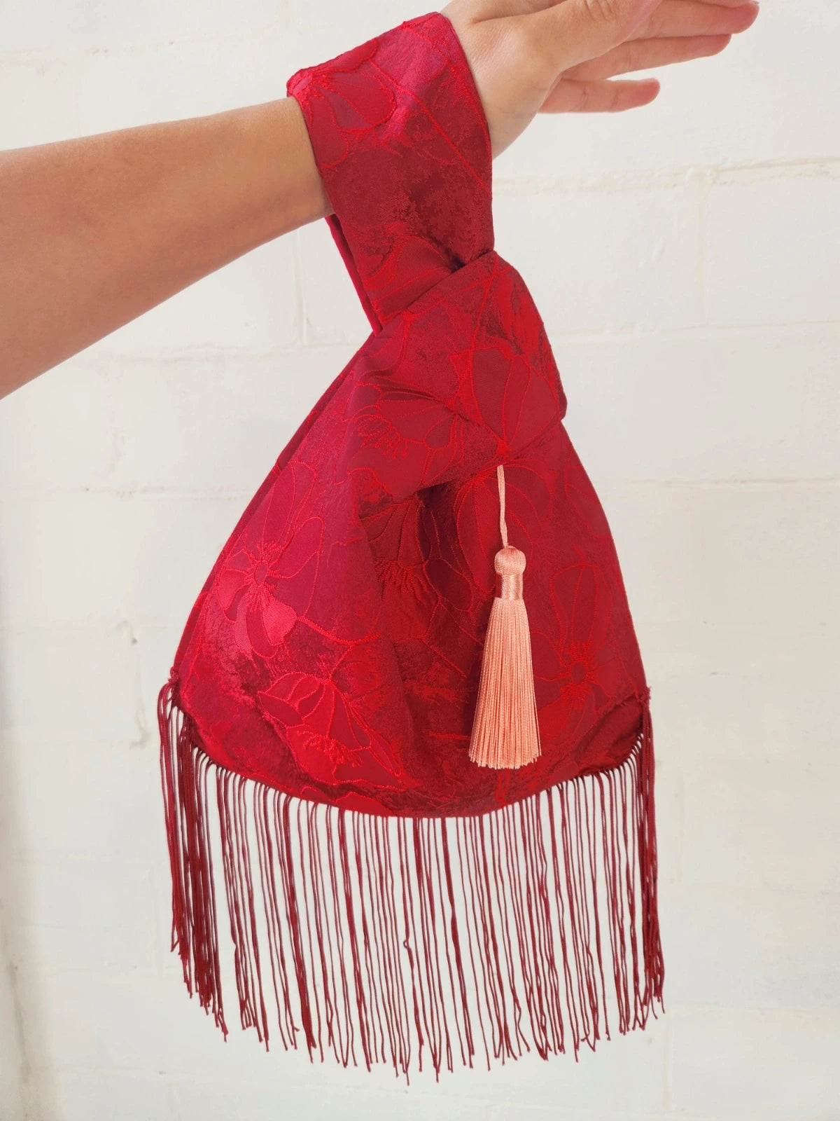 Japanese knot bag with a tassel fringe trim in red