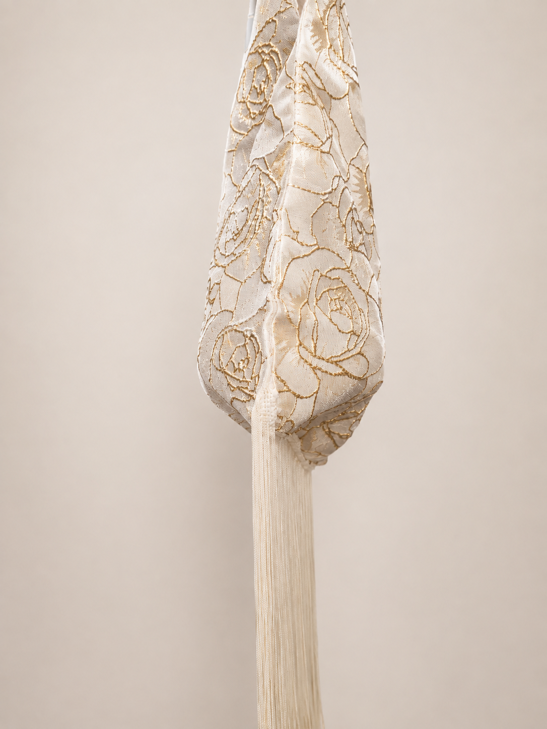 Japanese knot wrist bag in gold with a long fringe trim