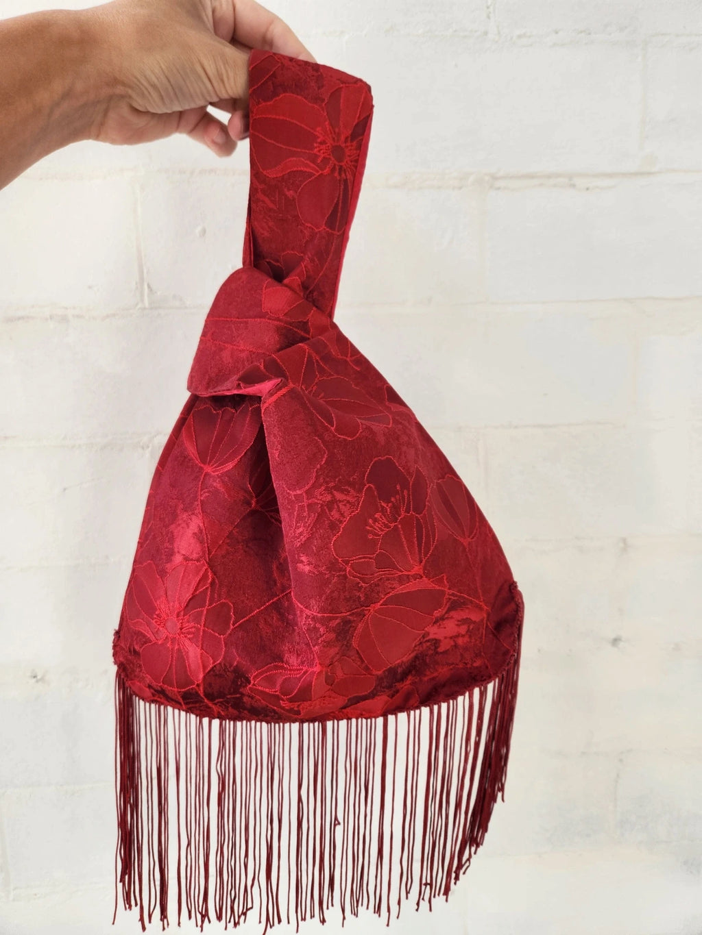 Japanese knot bag with a tassel fringe trim in red