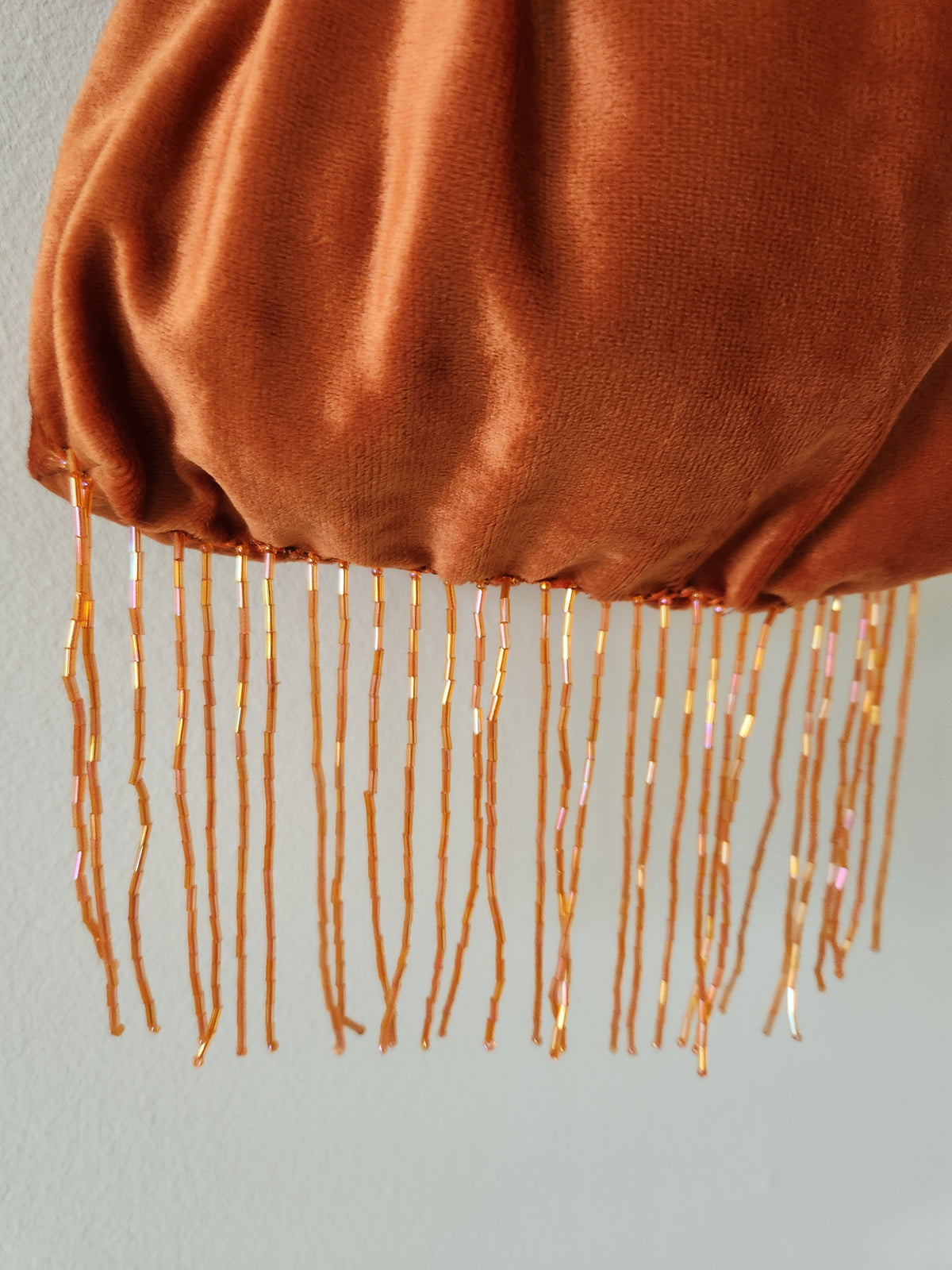 Japanese knot wrist bag with a beaded fringe trim