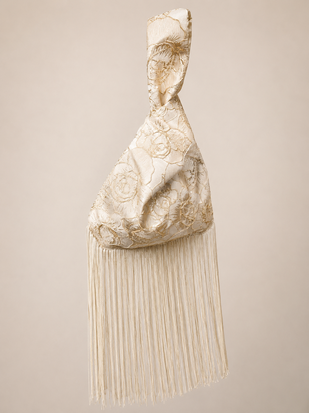 Japanese knot wrist bag in gold with a long fringe trim