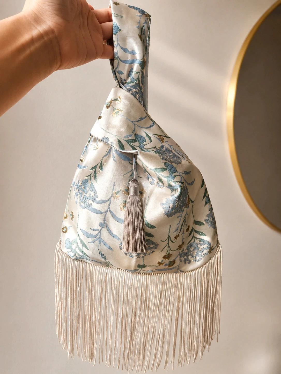 Japanese knot wrist bag with a tassel and a fringe trim