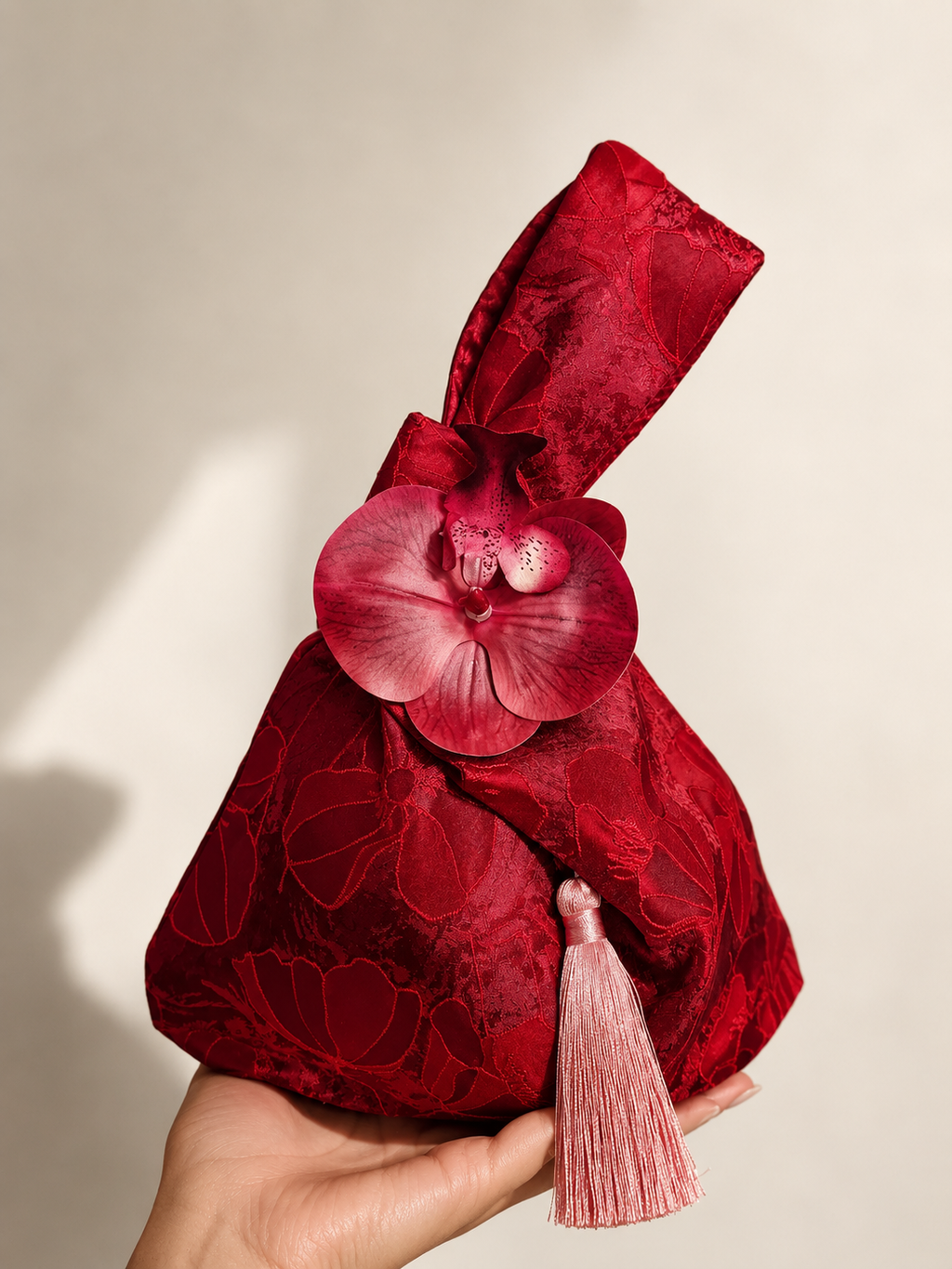 Japanese knot wrist bag with an orchid
