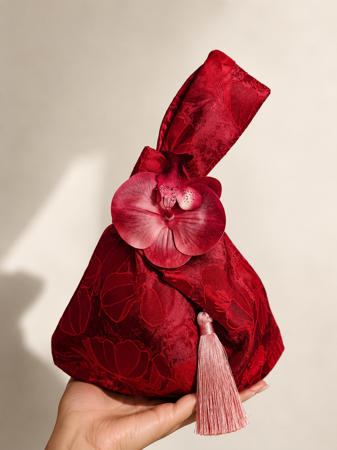 Japanese knot wrist bag with an orchid