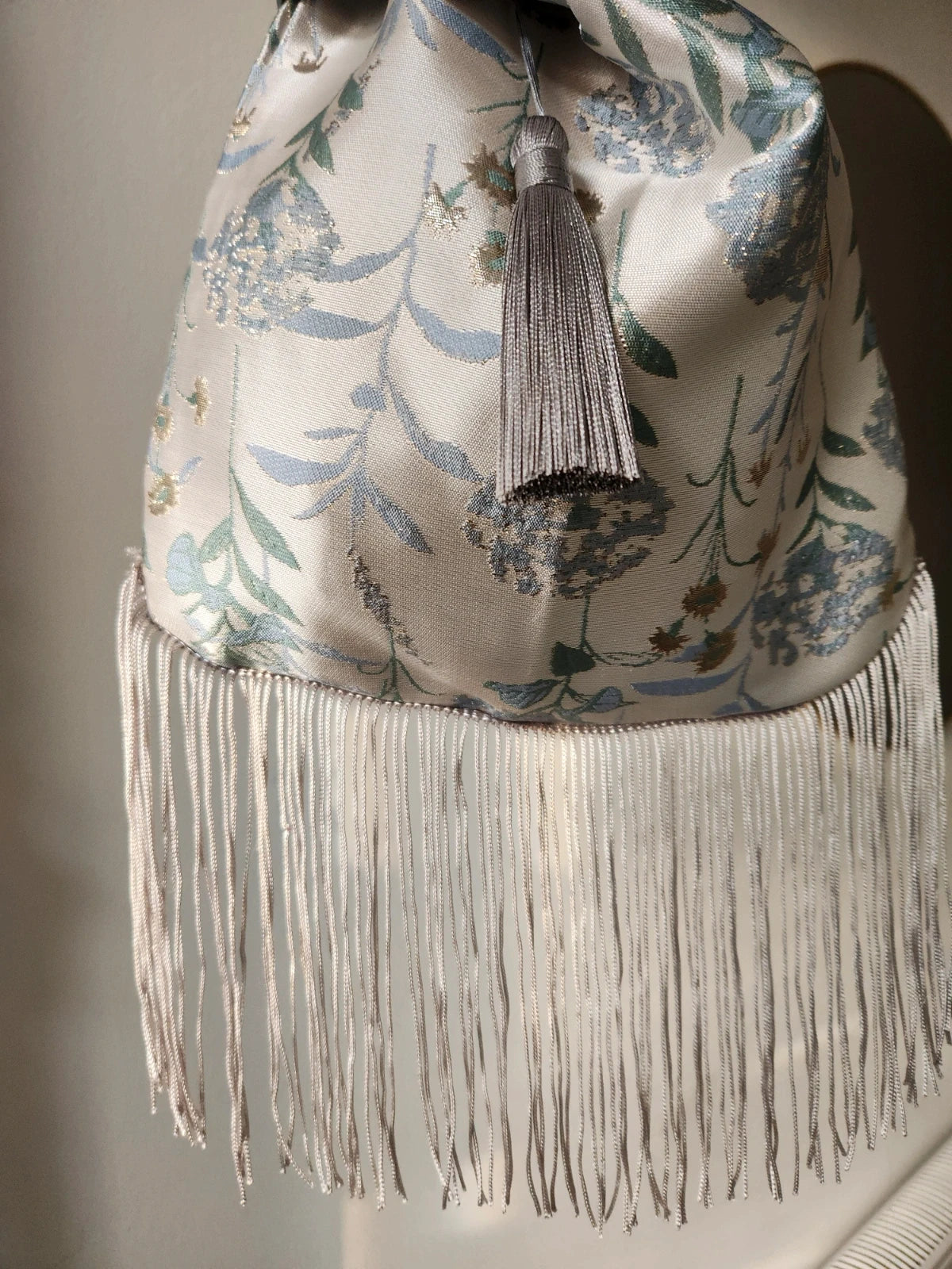 Japanese knot wrist bag with a tassel and a fringe trim
