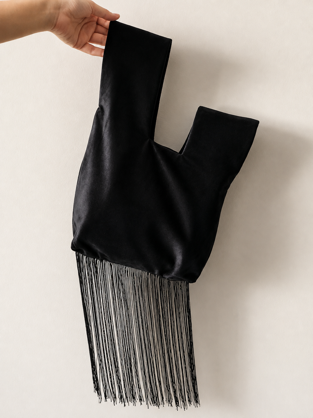 Japanese knot 'Medusa' black velvet bag with a fringe trim