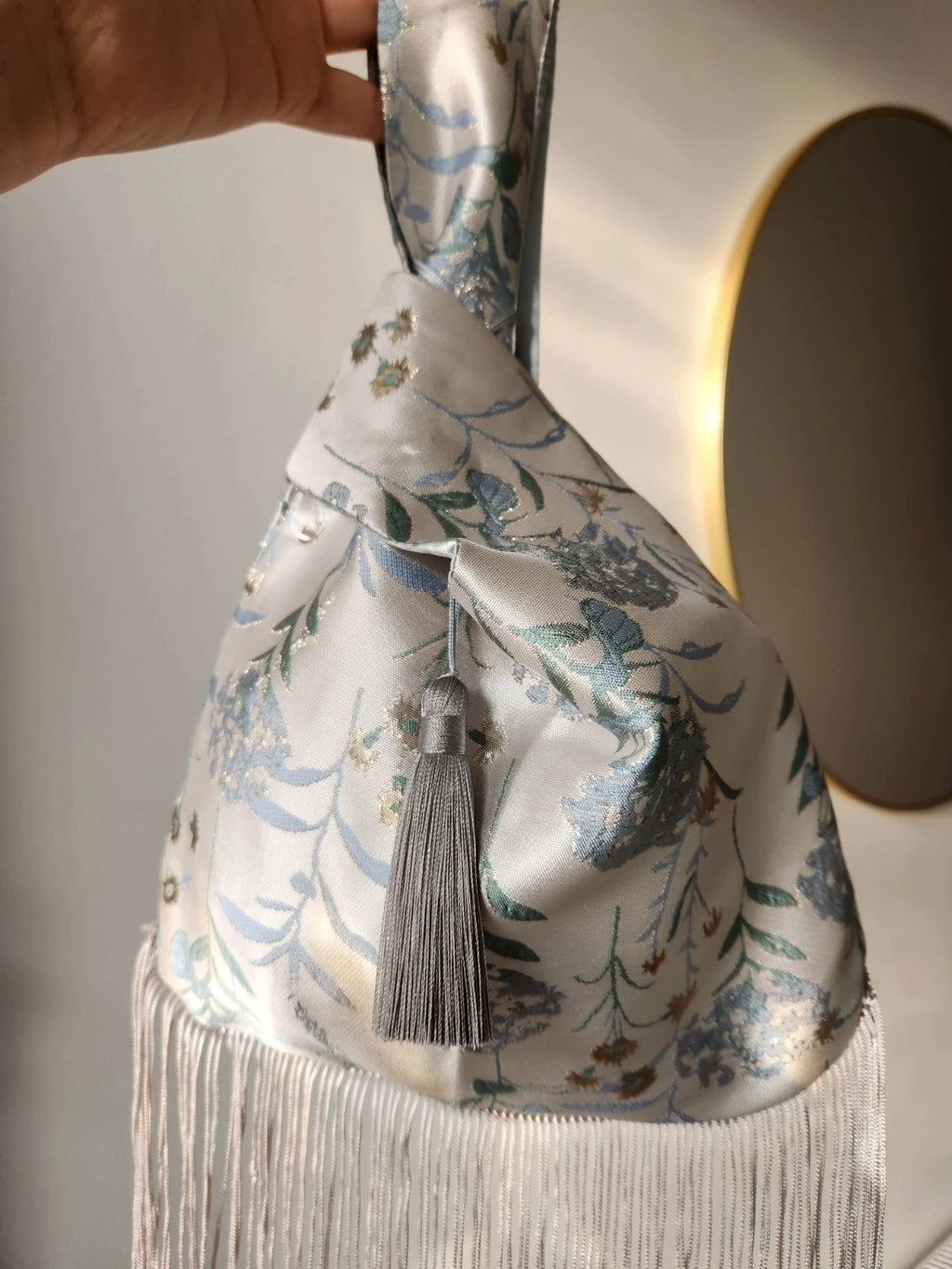Japanese knot wrist bag with a tassel and a fringe trim