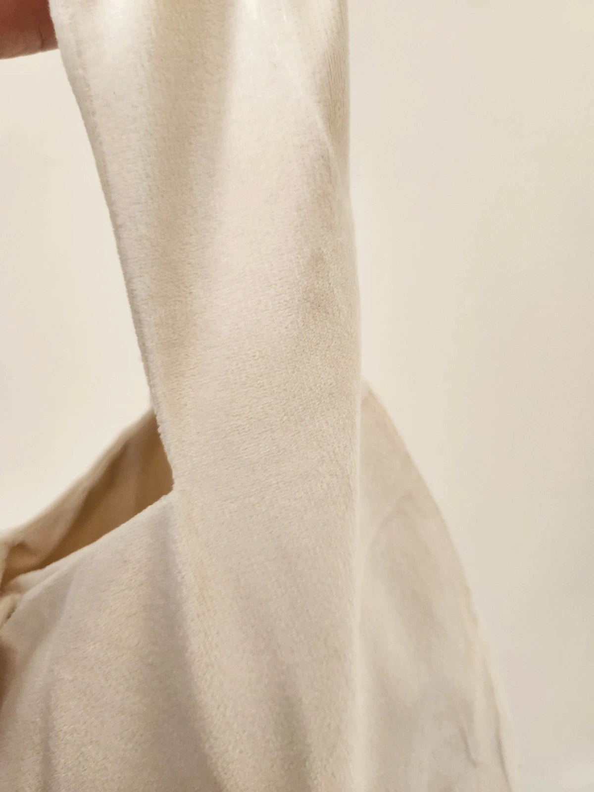 Japanese knot wrist bag in cream with a fringe trim