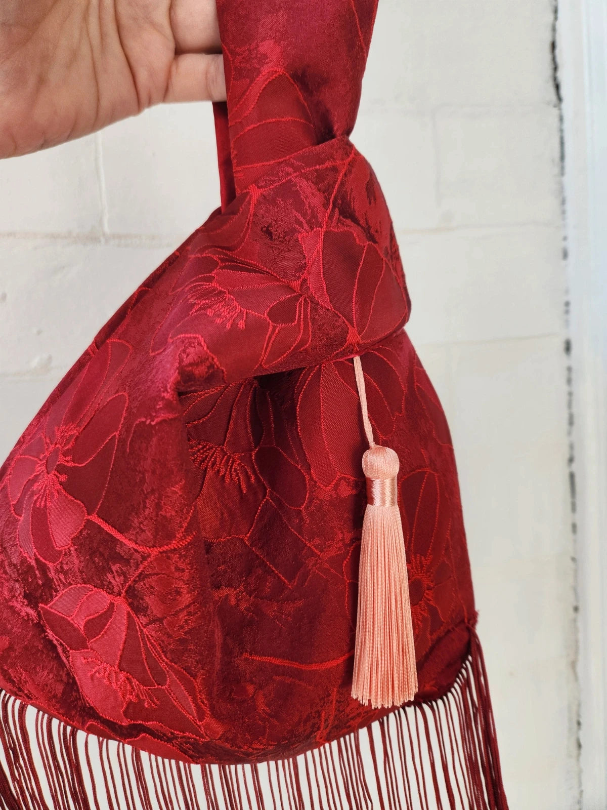 Japanese knot bag with a tassel fringe trim in red
