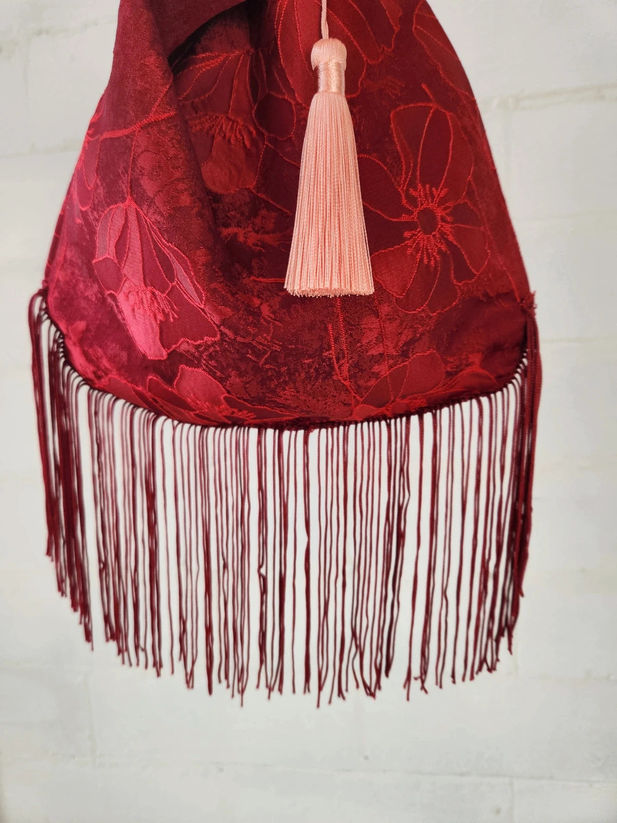 Japanese knot bag with a tassel fringe trim in red